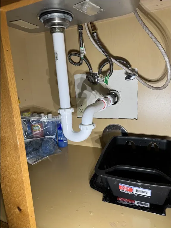 Plumbing modified and secured after a garbage disposal removal.
